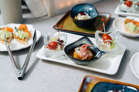 Gourmet bruschetta and profiteroles with plate. Luxury catering, modern food service.の写真素材