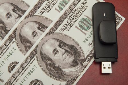 A hundred dollars on a red background, close-up. Electronic trading conceptの写真素材