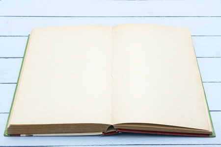 Book template with blank page on wooden table. Mockup for advertising, design. Education concept.の写真素材