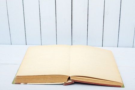 Open book on background woodens table and wall. Blank pages fo copy space or text.の写真素材