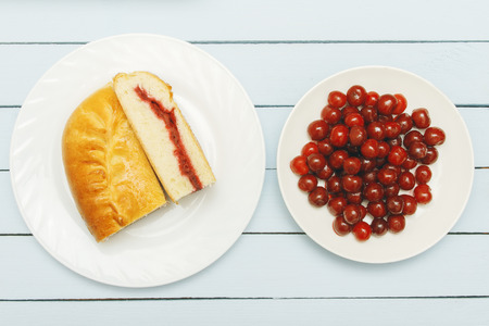 Heap cherries and piece pie on wooden table. Top view. Healthy food concept.の写真素材