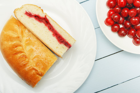 Two slice pie with cherry jam. Homemade dessert. Fresh berries for pastry.の写真素材