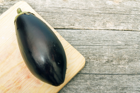 Top view on ripe eggplant. Vegetables on wooden table. Copy space.の写真素材