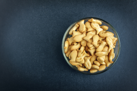 Delicious cookies in glass bowl on black background. View from above. Copy space.の写真素材
