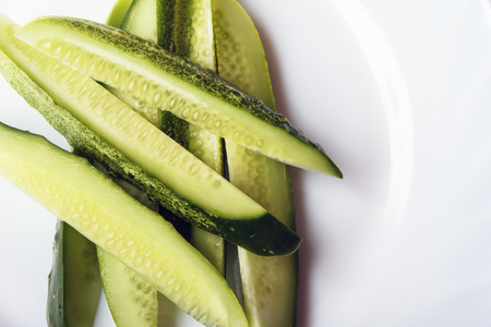 Sliced organic gherkins on white plate with space for text or copy space. Dietary food for healthy lifestyle. Top view.の写真素材