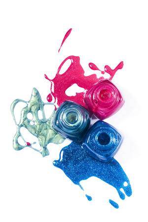 Top view of pink, blue, marine shimmering nail polish on white backgroundの写真素材
