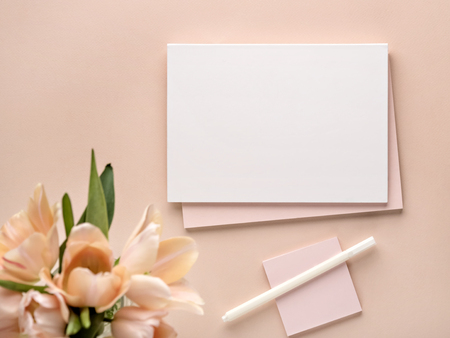 Mockup for your design in a pastel color, blank notebook, white pen and beauty flowers.の写真素材
