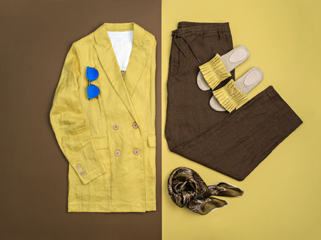 From above trendy yellow and brown female clothes and accessories on opposite background.の写真素材
