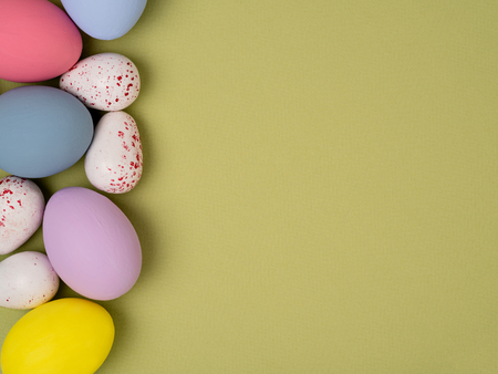 Bright and colorful Easter eggs flat lay composition with space for textの写真素材