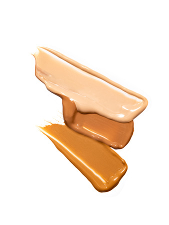 Composition of samples of liquid foundation, concealer isolated on white background. Skin care or make up products. Face makeup, cosmetics background.の写真素材