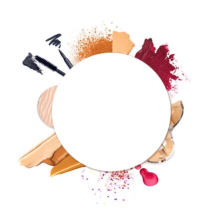 Crushed and smudged female facial cosmetics round frame. Decorative cosmetics arranged in a circle isolated on white background. Beauty and makeup concept. Copy space for text.の写真素材