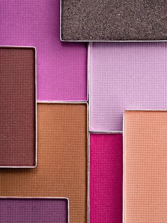 Colorful palette of eye makeup. Top view of lilac, beige, violet, brown and fuchsia pink eyeshadows. Cosmetics products background in trendy color scheme.の写真素材