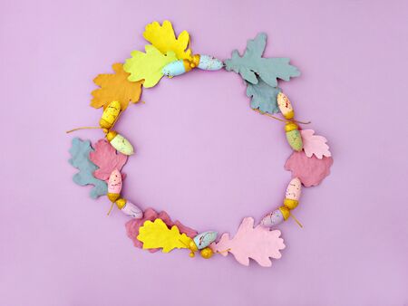 Colorful wreath made of hand dyed autumn leaves. Creative fall background. Autumn or Thanksgiving holiday concept card. Flat lay, top view, copy space for text.の写真素材