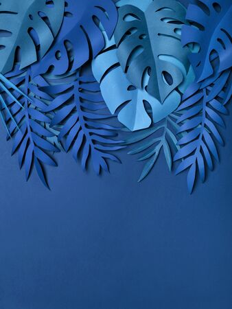 Hand made paper tropical Leaves toned in trendy blue color. Modern minimalist top frame or border. Color of the year 2020 classic blue.の写真素材