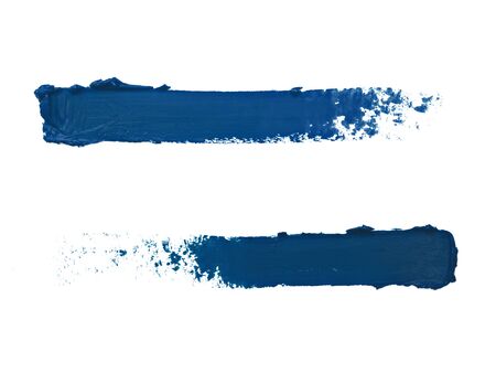 Image of makeup strokes made in opposite direction in trendy classic blue scheme isolated on white background. Smudged cosmetics. Trendy deep blue makeup texture, cosmetics concept. Color of the year 2020.の写真素材