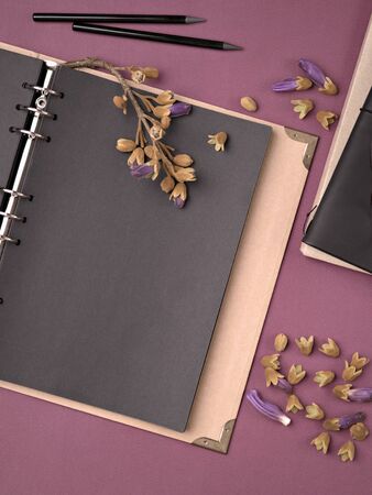 Cosy home work place with old fashioned black blank notebook or photo album. Moody template, mockup. Top view, copy space for text.の写真素材