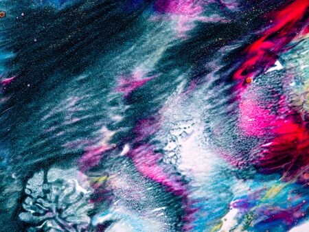 Close-up fragment of nail polish or paint texture with marble pattern. Moody liquid paint background. Mix of vibrant colours. Abstract art wallpaper.の写真素材