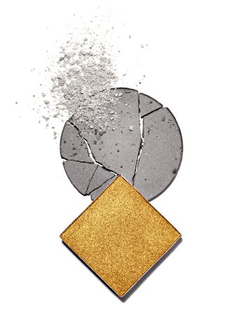Ashy and gold eyeshadow palette for eye makeup isolated on white background. Cosmetics for creating dramatic smokey or seductive matte looks. Texture or background for layout design.の写真素材