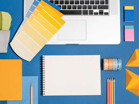 Home office flat lay for self employed freelance girl. Bloggers minimalist workplace with color samples, blank notebook, office supplies. Mockup for text, sketch, image.の写真素材