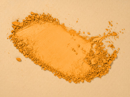 Top view of smudged eyeshadow sample toned in trendy marigold colour. Makeup and cosmetics background. 2021 color trend concept.の写真素材