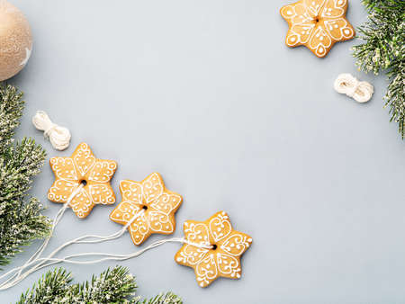 Christmas background with homemade gingerbread cookies as a decoration and spruce branches. Festive food, New Year celebration, traditions, winter holiday and culinary concept. Copy space.の写真素材