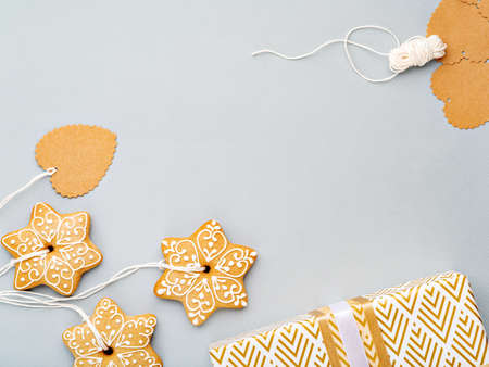 Christmas background with homemade gingerbread cookies as a decoration and matching gift tags. Festive food, New Year celebration, traditions, winter holiday and culinary concept. Copy space.の写真素材