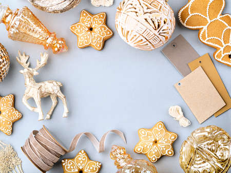 Old fashioned Christmas or New Year concept. Winter holidays frame with gingerbread cookies, gift boxes, ribbons, vintage baubles and decoration. Greeting card or invitation mockup with copy space.の写真素材
