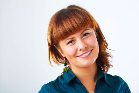 Happy young woman smiling with friendly lookの写真素材