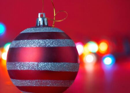 Christmas ornament on red blured backgroundの写真素材