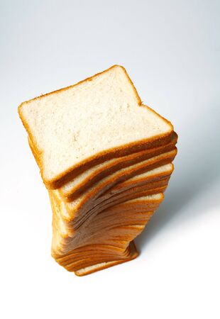 Sliced white bread for toasts on white background.の写真素材