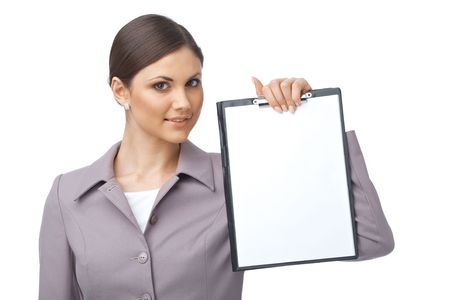 Businesswoman holding an empty clipboard over white backgroundの写真素材