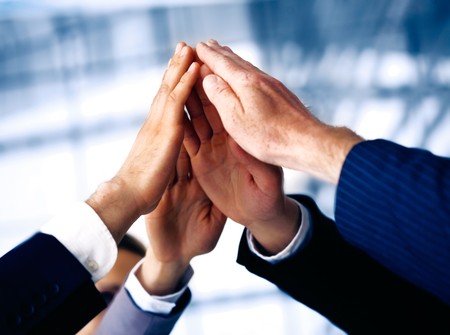 Hand of the business people forming a pyramid in the air.の写真素材