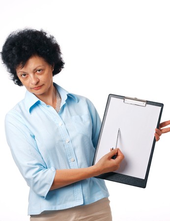 Serious elder woman holding a clipboard and showing something over white.の写真素材