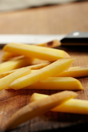 Slicing Potatoes on a Cutting Board  Close up viewの写真素材