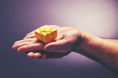 very delicate gift from reliable men's handsの写真素材