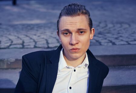 young businessman sitting on a staircaseの写真素材