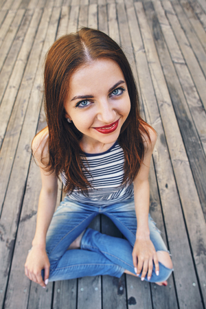 girl relaxing on a wooden floor . Relax, rest, education concept, recreation .の写真素材