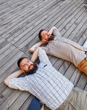 a two businessmen in a break between work. He relaxes looking into the skyの写真素材