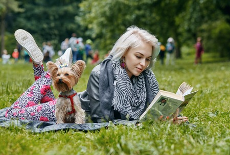 a Portrait of a young woman with a little dogの写真素材