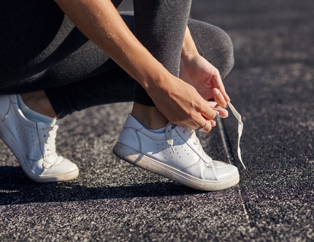 Running shoes - closeup of woman tying shoe laces.の写真素材