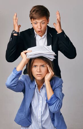 portrait of two people. Problems in their business relationships. The Chief loads the subordinate