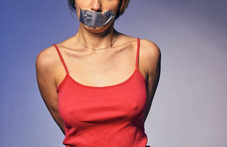 young woman and violence. photo of a woman with her lips stuck together.の写真素材
