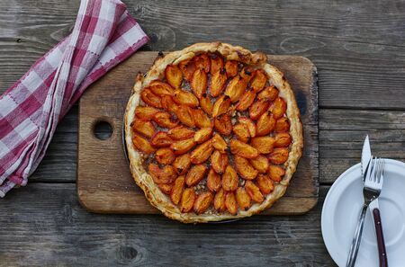 Apricot almond cake on puff pastry. Delicious summer breakfastの写真素材