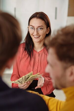 young business woman showing her monetary achievementsの写真素材