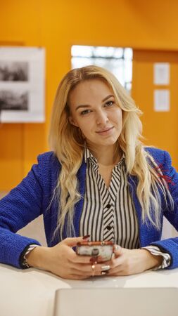 smiling business woman in blue jacket in office