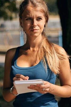 a beautiful young woman with note at outdoor