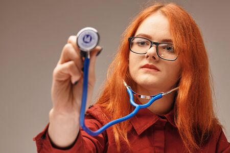 woman with phonendoscope she wants to feel subtle sensationsの写真素材