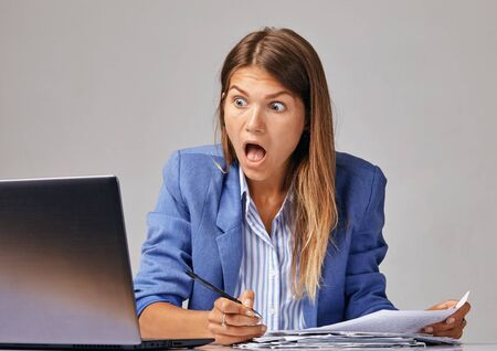 serious businesswoman working at the modern office desk with laptop, nervous breakdown, waiting for interview, exam, medical test result, financial issues anxiety, single woman depressionの写真素材