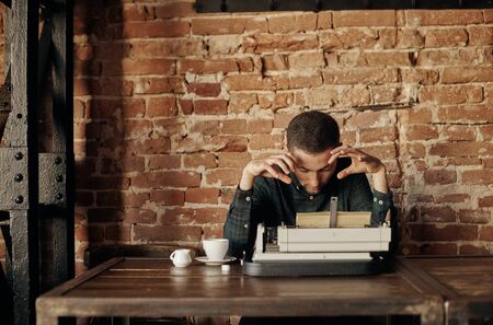young writer with a classic typewriter. hes going to work