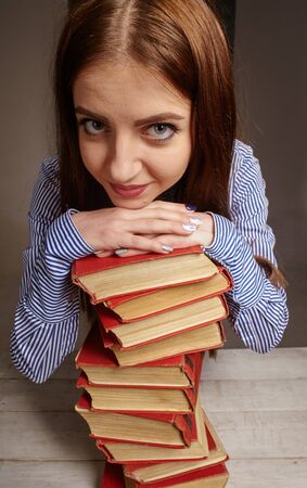 woman with stack of books she wants to studyの写真素材